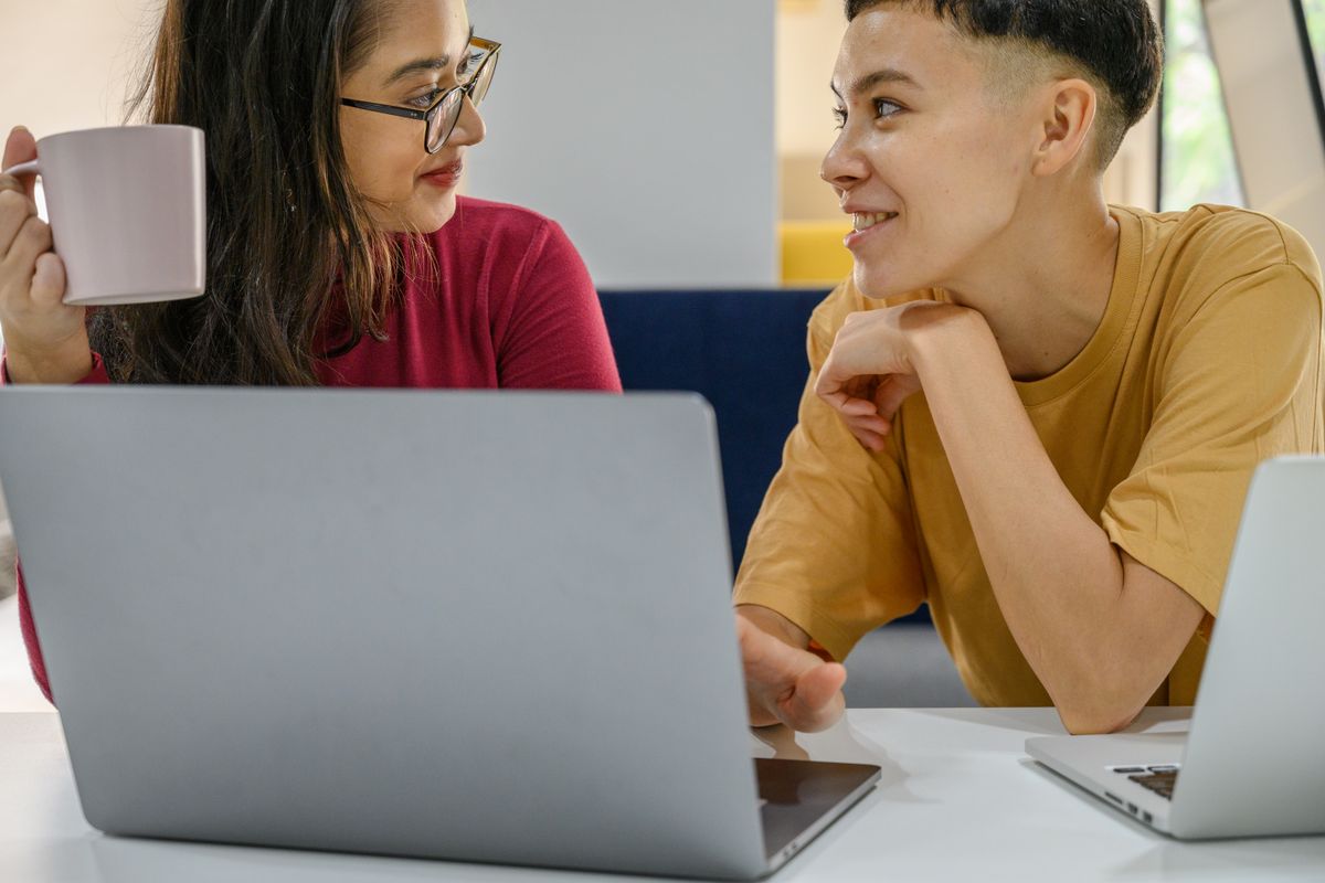 A pair reviewing records on screen